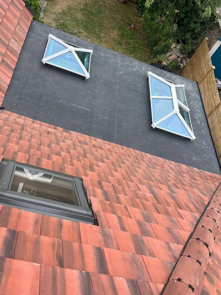 This is a photo taken from the roof ridge looking down a tiled pitched roof on to a flat roof. Works carried out by TRP Roofing Driffield