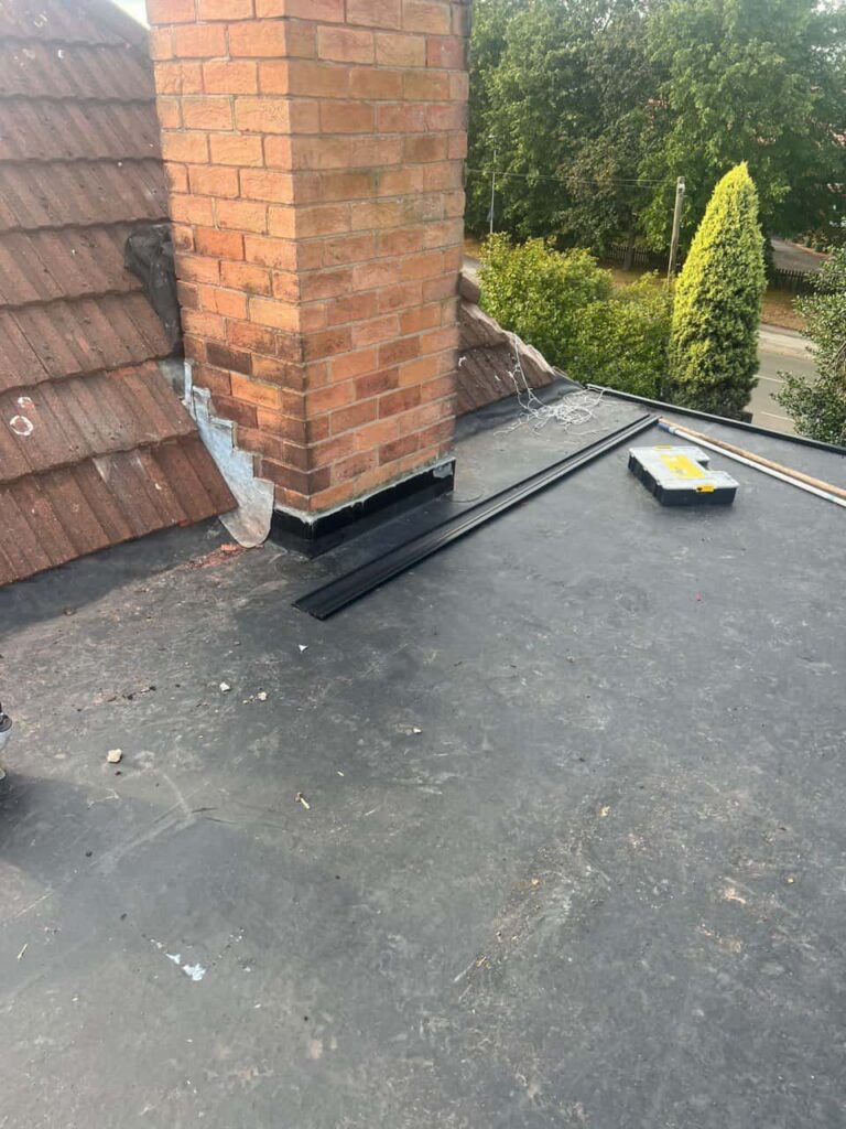 This is a photo of a flat roof which has just been repaired, there is also a chimney stack and some leadwork has also been dressed. Works carried out by TRP Roofing Driffield